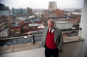 Tom Huff admires the view of downtown Kalamazoo from his balcony